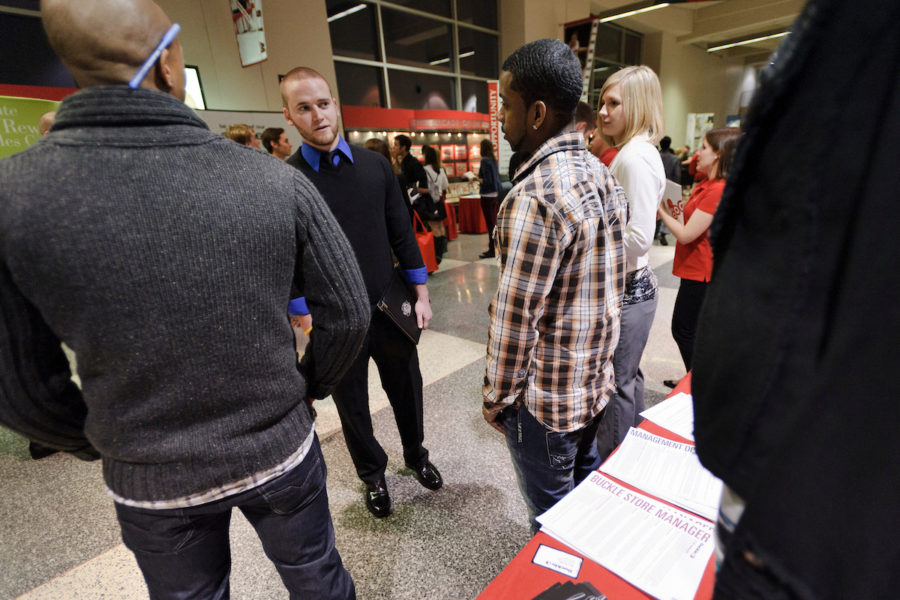 Photo of student talking with representatives from the retail company Buckle at the Spring Career and Internship Fair.